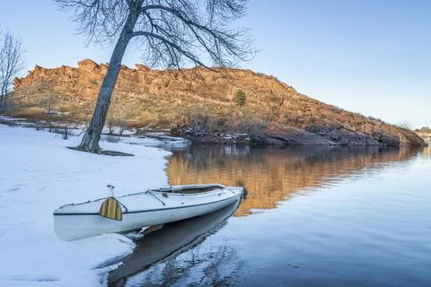 Decked expedition canoe in winter scenery Stock Photos