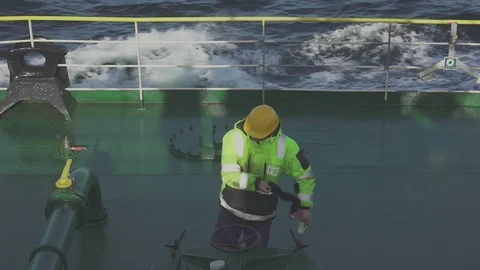 Deckhand cleans stop pipeline valves from oil on tanker deck Stock Footage 121117606