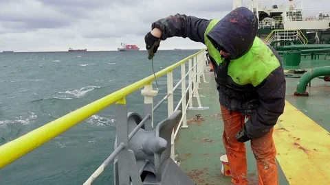 Deckhand paints railing on large oil tanker deck in sea Video stock 121117056