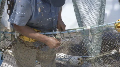 Deckhand tying knots on shrimp boat Stock Footage 104882011