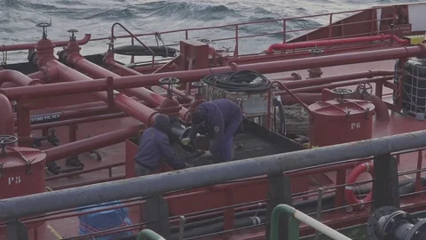 Deckhands prepare pipe to connect hose for bunkering Stock Footage 121117231