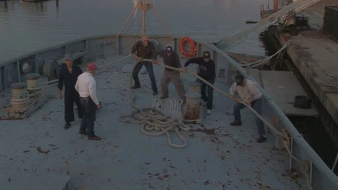 Deckhands working the stern line on Coast Guard Cutter in Baltimore, Maryland US Stock Footage 105547569
