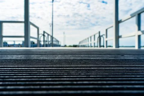 Decking is laid on the pier. Defocus low view. Stock Photos