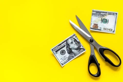 Decline of dollar exchange rate. Scissors cut dollars banknote Stock Photos