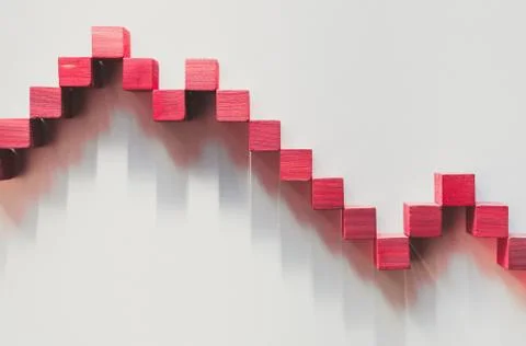Declining red graphic curve made with wooden boxes. Financial concept Stock Photos