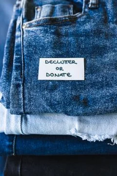 Declutter and Donate label on different jeans in various denim colors, tidyin Stock Photos