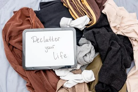Declutter your life text on board on cloth background, trend clearing space Photos