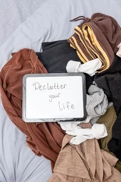 Declutter your life text on board on cloth background, trend clearing space 库存照片