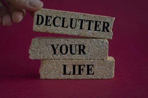 Declutter your life word written on brick blocks on a red background. Foto stock