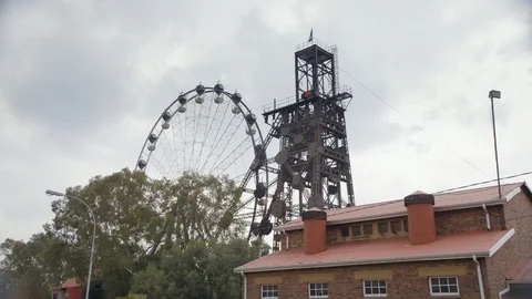 Decommissioned mining tower with ferris wheel in background Stock Footage 123916537