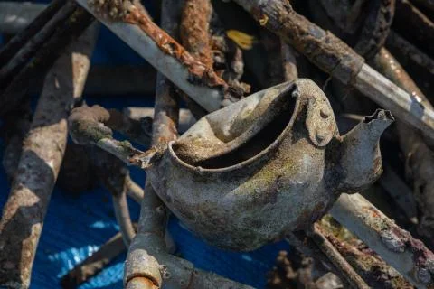 Decomposing metal a decayed tea pot along with lots of different metals taken Stock Photos