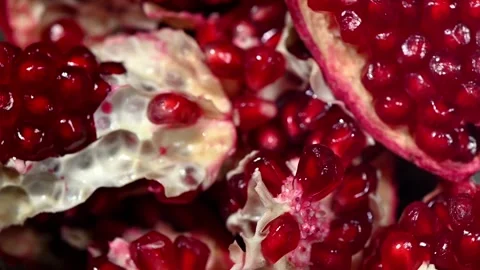 Deconstructed Pomegranate Spinning on Surface. Ruby Red Seeds in Slow Motion Video stock 325811535