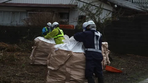 Decontamination Workers Sealing Bulk Waste Bags in Futaba Vídeos de archivo 347672955