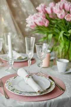 Decor and spring table setting is a vase with pink tulips Stock Photos