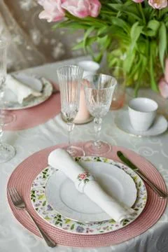 Decor and spring table setting is a vase with pink tulips Stock Photos