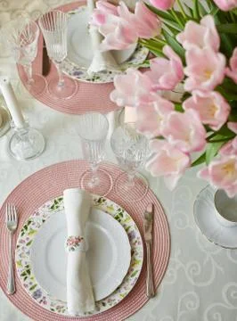 Decor and spring table setting is a vase with pink tulips Stock Photos