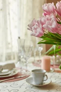 Decor and spring table setting is a vase with pink tulips Stock Photos