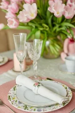 Decor and spring table setting is a vase with pink tulips Stock Photos