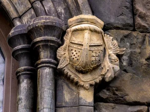 Decor of the arch in the form of the front part of the helmet of a medieval w Stock Photos