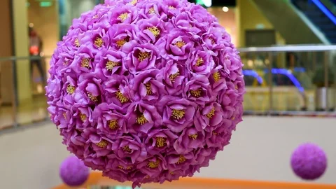Decor of artificial flowers in the shape of a ball in artificial light Stock Footage 105987369