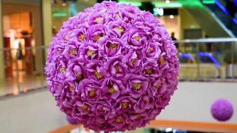 Decor of artificial flowers in the shape of a ball in artificial light Stock Footage 105987372