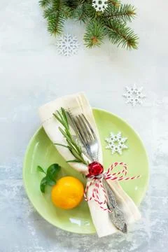 Decor Christmas table on stone background. Green plate, cutlery. Stock Photos