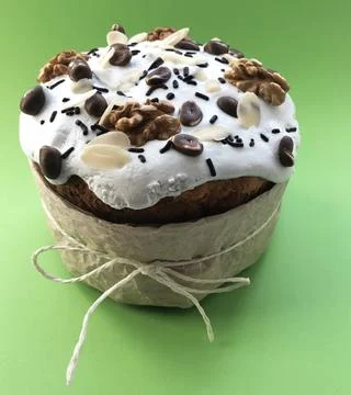 Decor Easter cake with peanuts and nuts on green background Stock Photos