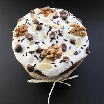 Decor Easter cake with peanuts and nuts on black background Stock Photos