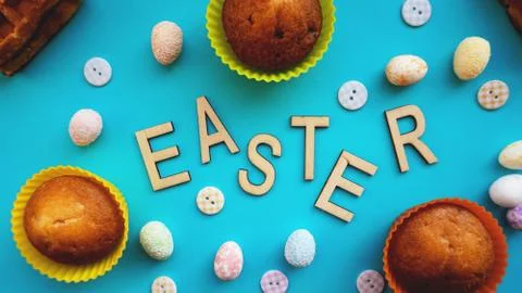 Decor Easter eggs on blue background. Flat lay, top view. Easter concept. Stock Photos