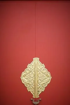 Decor element on the red gate of a Buddhist temple in Japan Stock Photos