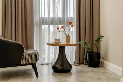 Decor elements of the guest room and rest room with a tea table, an armchair  Stock Photos