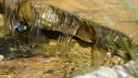 Decor in the Park, a small waterfall, slow motion water falls from the rocks. Stock Footage 92156162