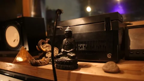 Decor on a shelf in a recording studio. Buddha, pyramid, elephant, music column  Stock-Footage 218363301
