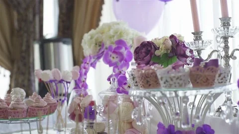 Decor, sweet table. White table with sweets. Wedding cakes and flowers. Cupcake. Stock Footage 76131857