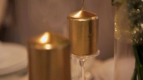 The decor of the table. Golden candle. close-up Stock Footage 75538425