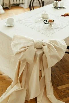 Decor tied tablecloth in the shape of a bow tie on a table in the kitchen living Stock Photos