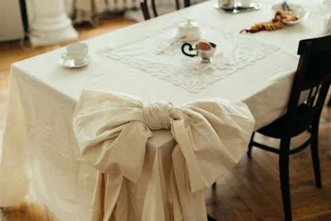 Decor tied tablecloth in the shape of a bow tie on a table in the kitchen living Stock Photos