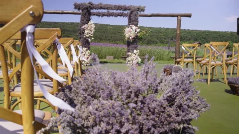 Decor for the wedding ceremony of the bride and groom with lavender flowers in Stock Footage 278406580