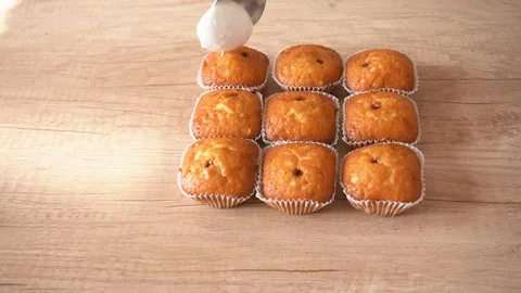 Decorate Easter cupcakes with cream. Using spoon. home baking concept Stock Footage 112397339