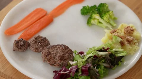 Decorate the meatballs with vegetables Stock Footage 183569595