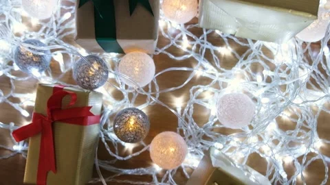 Decorate the table with gift boxes and led lights. Surprise gifts are waiting fo Vídeo Stock 142057280