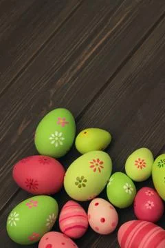 Decorated and painted pink and green easter eggs on wooden background Stock Photos