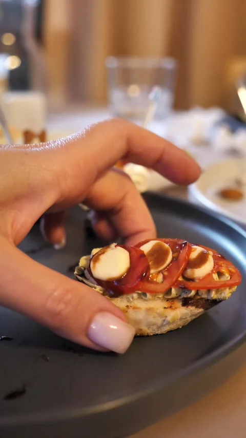 Decorated banquet table with canapes snacks. Female hand takes canapes Stock Footage 313237177