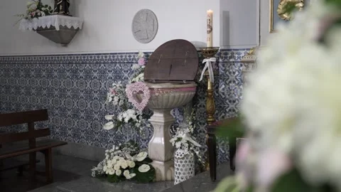 Decorated baptismal font with flowers inside church Stock Footage 331047411
