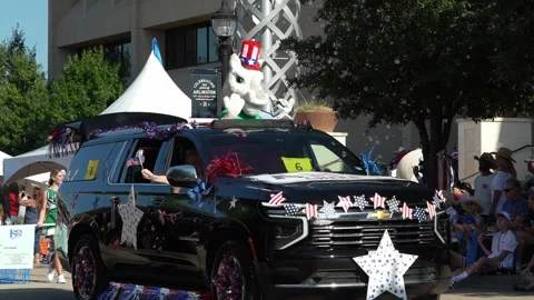 Decorated black SUV parade float with mascot and patriotic bunting Stock Footage 340940853