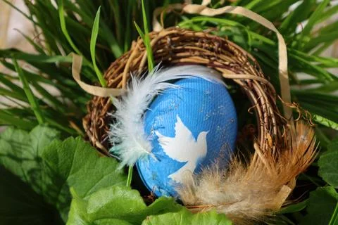 Decorated Blue and Gold Easter Egg in a Rustic Nest with Grass Stock Photos