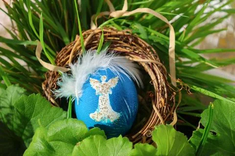 Decorated Blue and Gold Easter Egg in a Rustic Nest with Grass Stock Photos