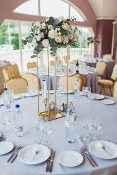 Decorated blue wedding table with plates and flowers 写真素材