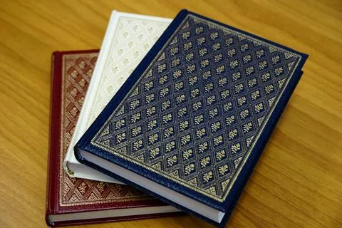 Decorated book binding adorned with an antique pattern of golden rose flowers Stock Photos