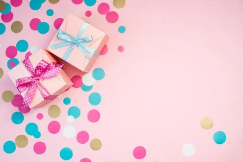 Decorated boxes and confetti on the pink background. Stock Photos